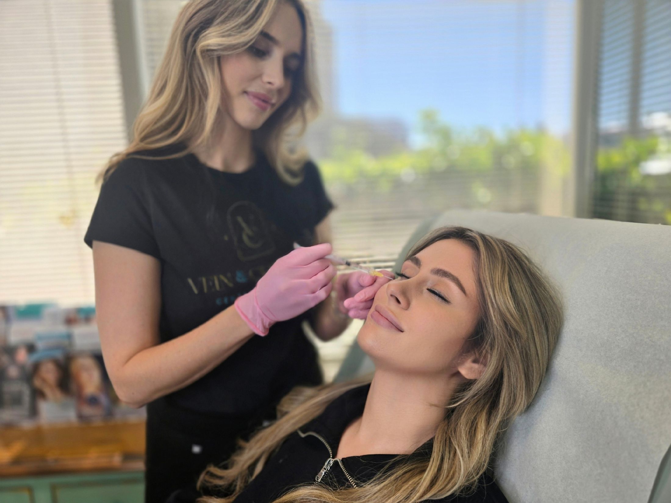 Woman receiving cosmetic treatment in clinic setting.