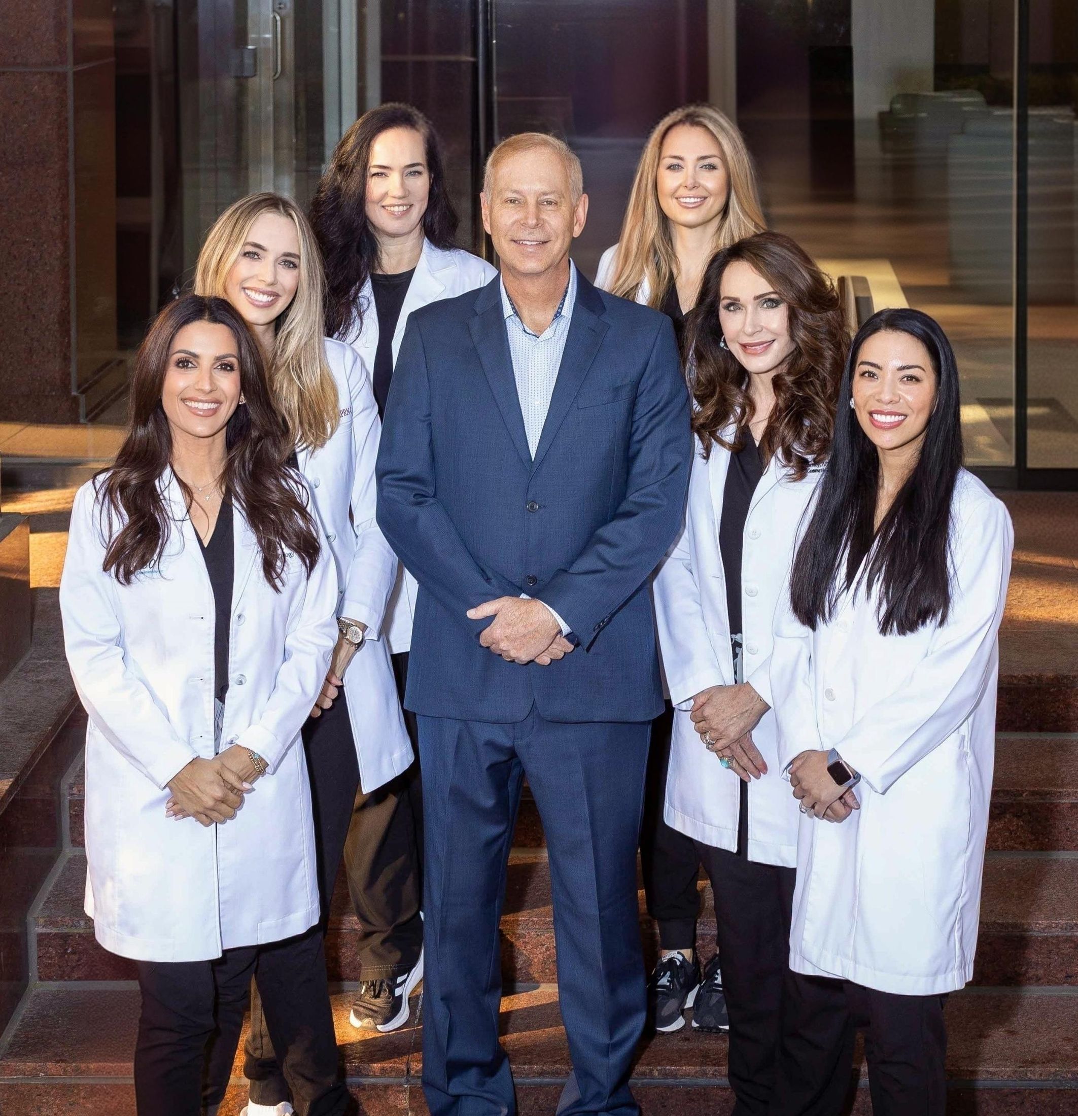 Medical team posing outside a building.