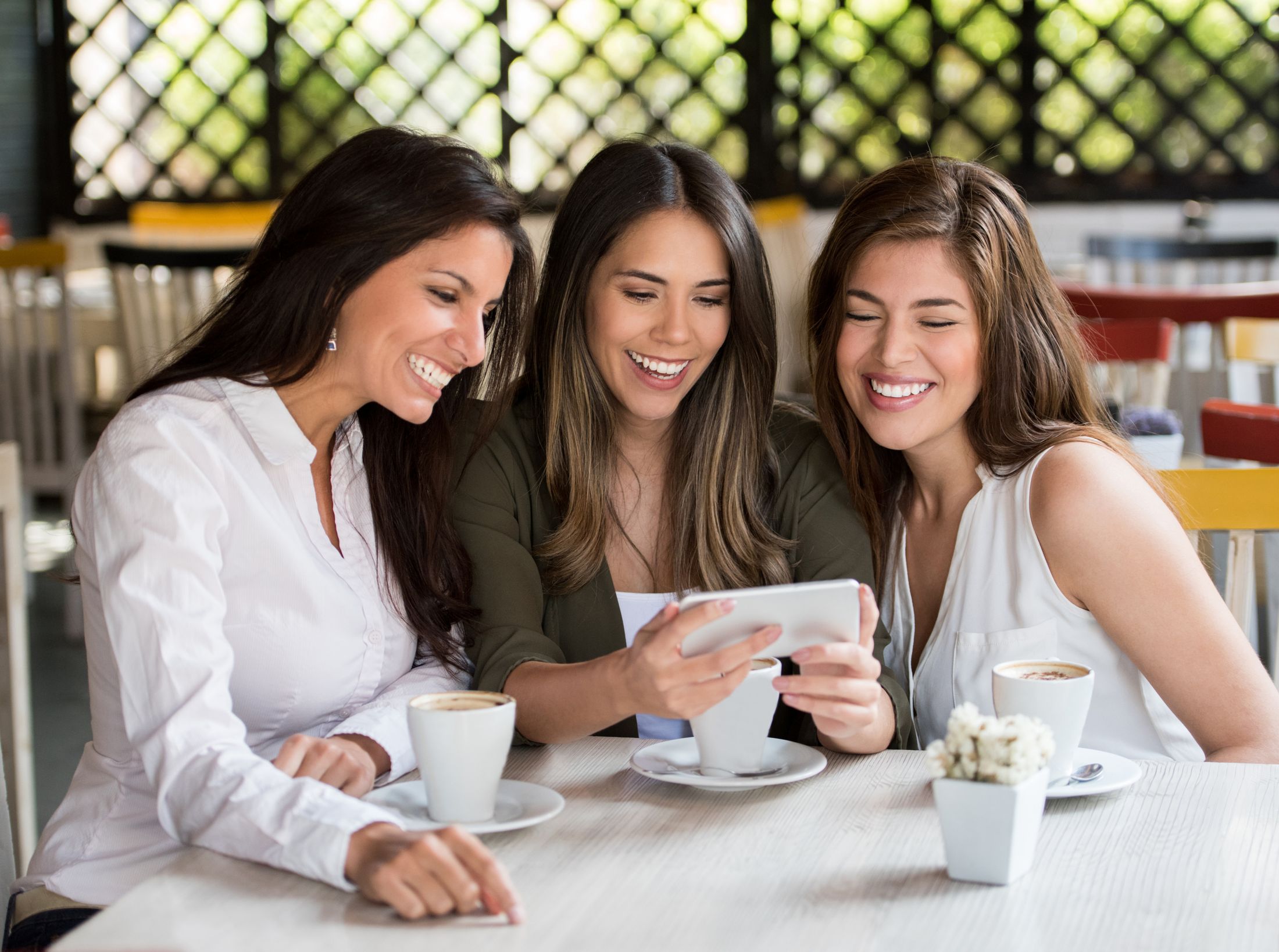 Three smiling women enjoying time together.