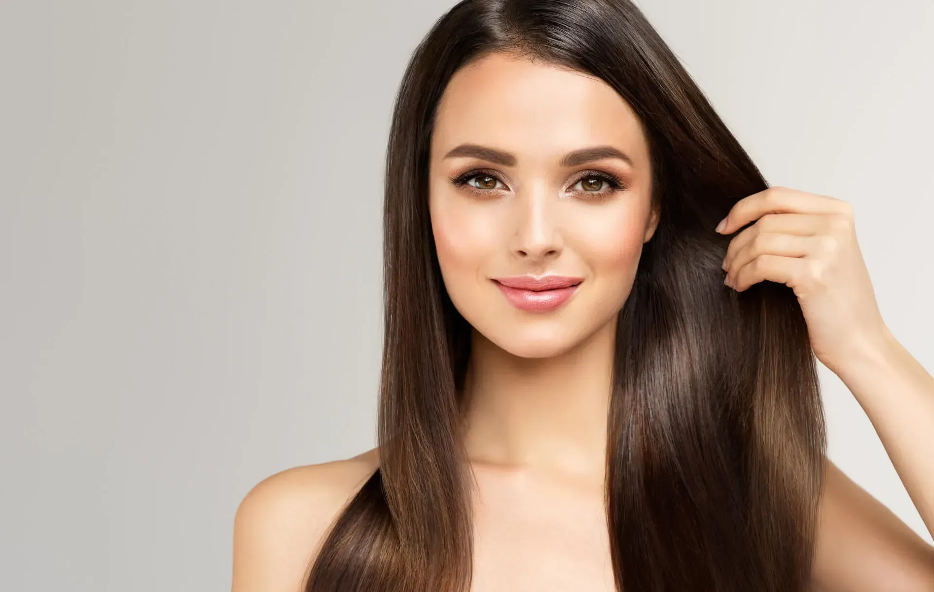 Smiling woman with long, sleek hair.