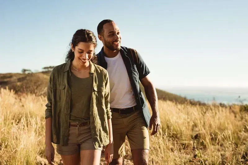 Couple hiking together in scenic outdoor setting.