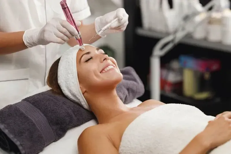 Woman receiving a skincare treatment in spa.