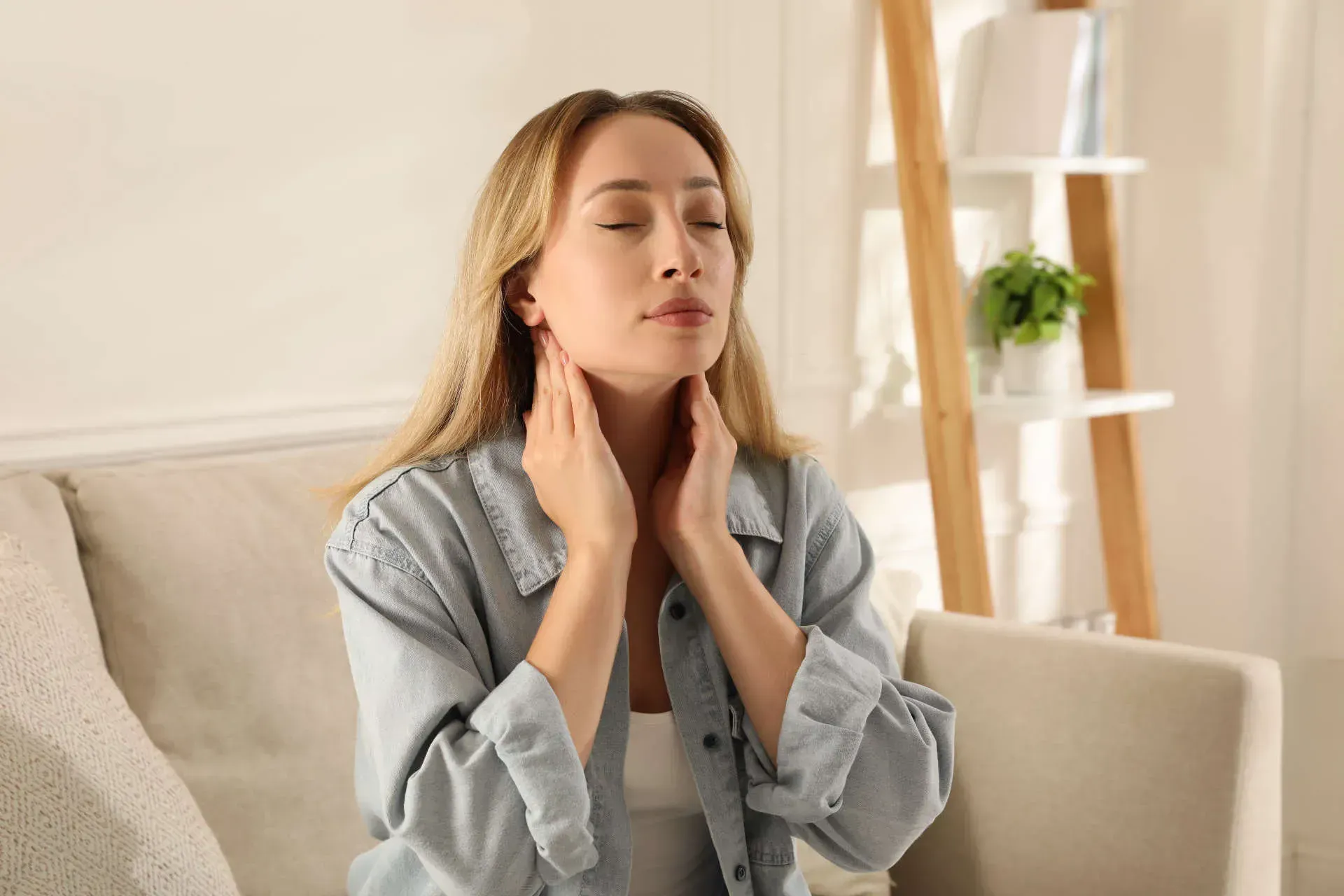 Woman relaxing and massaging her neck.