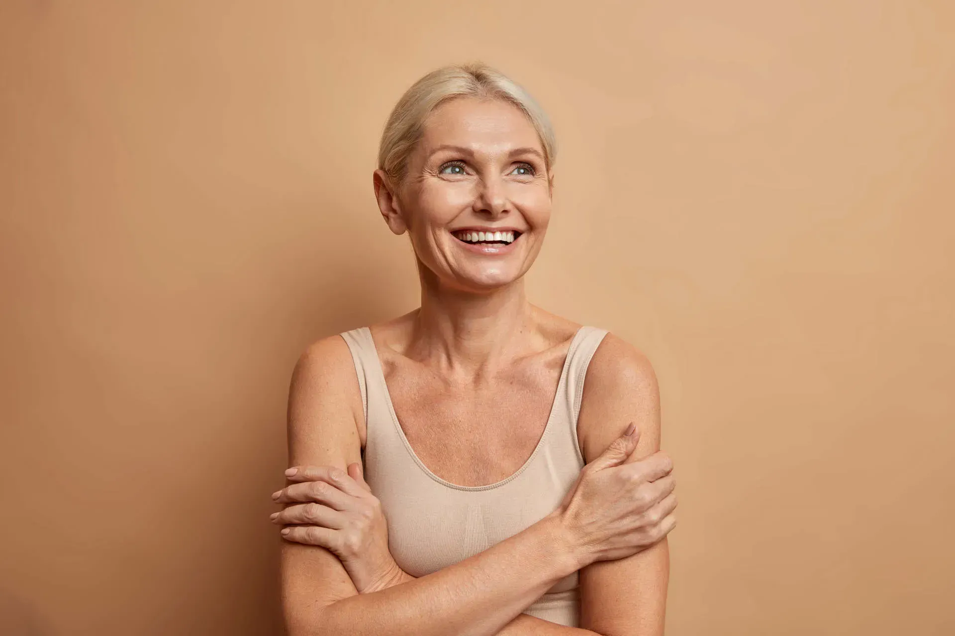 Smiling woman with light skin and blonde hair.